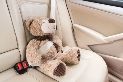 Children's toy is strapped in the car.