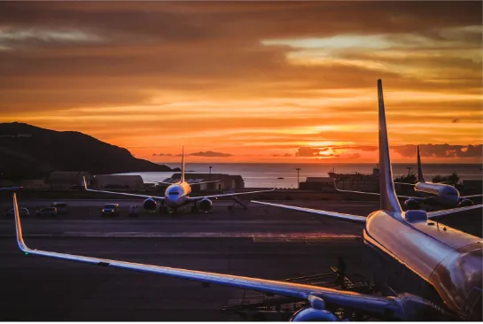 Airplane on the background of the sea and sunset