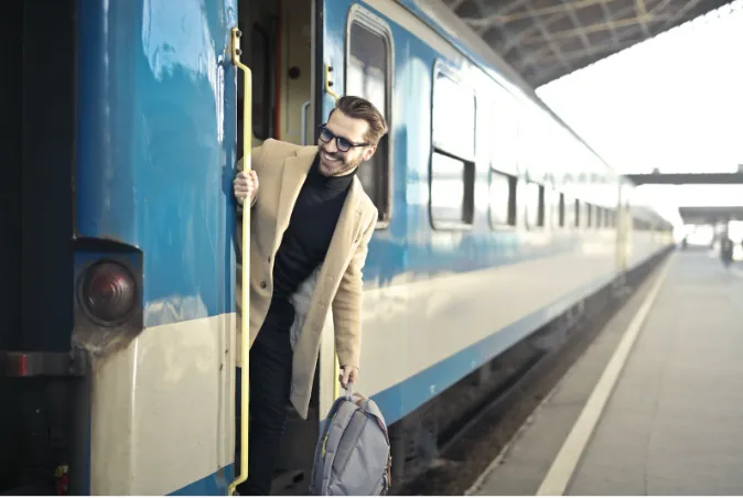 A man rides a train to the airport