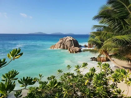 Granite boulders and turquoise water at a beach in the Seychelles