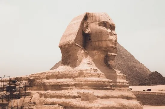 The statue of the Sphinx next to the pyramids of Giza Egypt